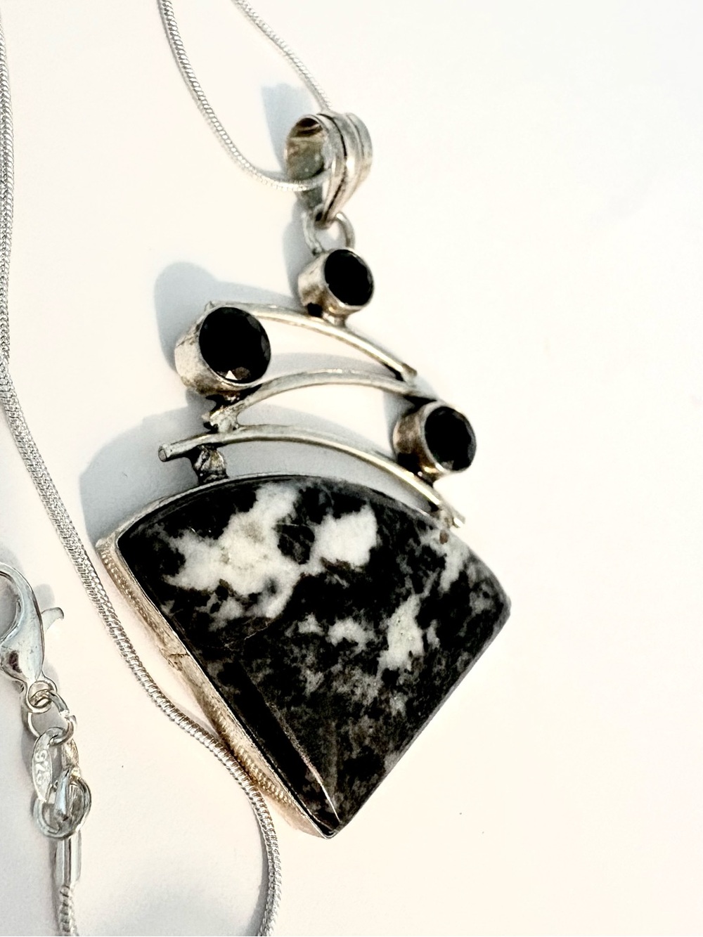 2 1/2 inch, Buffalo Turquoise pendant with 3 Black Onyx, on a silver chain.